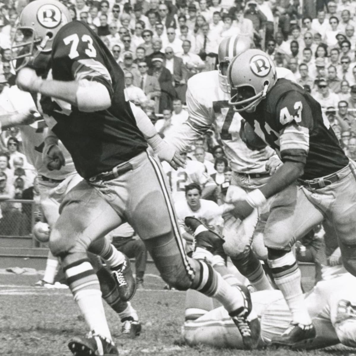 Washington Redskins running back Larry Brown is brought down in