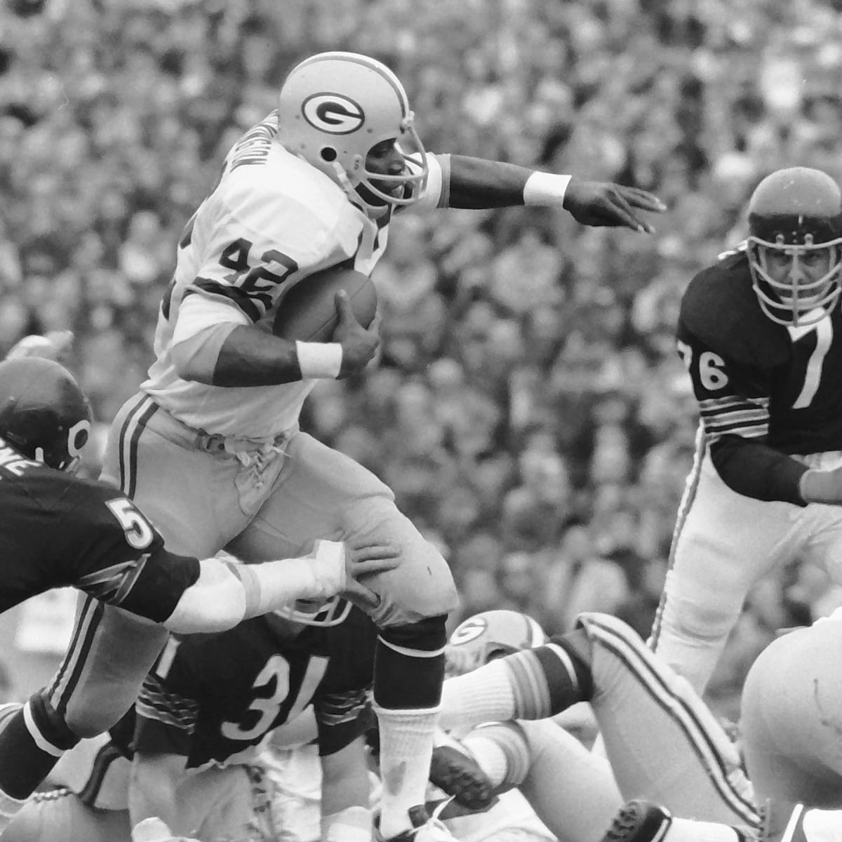 John Brockington (42) of the Green Bay Packers is seen picking up