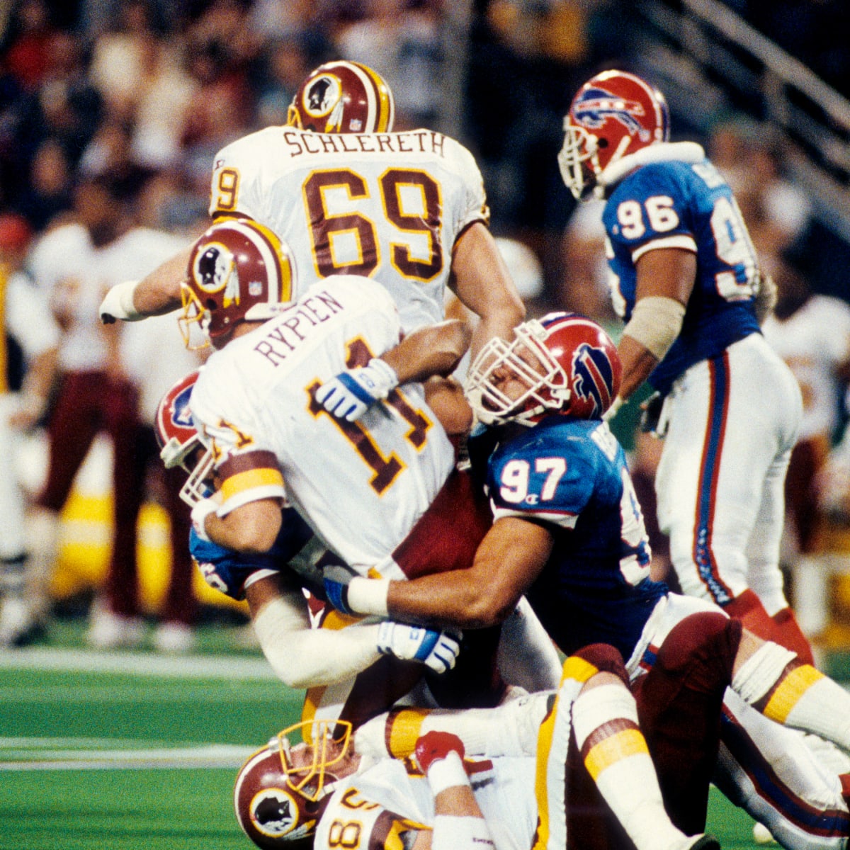 Buffalo Bills linebacker Cornelius Bennett, right, helps Houston